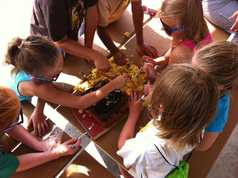 Campers at the Can You Dig It? Adventures in Dirt Camp got down and dirty exploring all the things that are found in the dirt that tell us about the past. They explored mock archaeological digs, visited the site where a 17,000 year old mammoth was found, played Native American games, examined prehistoric artifacts, and paddled their way into the past. Favorite activities included exploring an archeaological dig site made out of cake, making their own pottery, and reconstructing broken pottery sherds like real archaeologists!