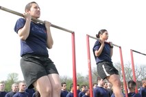Female poolees perform the flexed arm hang during an all hands pool function.