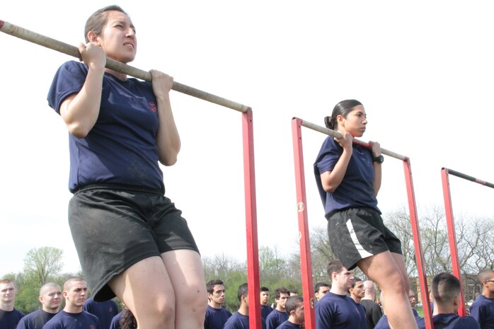 Female poolees perform the flexed arm hang during an all hands pool function.