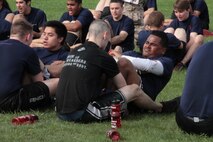 Poolees are required to perform crunches as part of the intital strength test. Here the poolees are doing so during an all hands pool function and competing against other sub-stations withing Recruiting Station Chicago.
