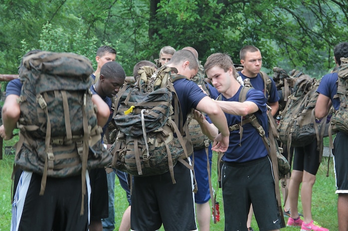 Poolees from Recruiting Sub-station Fox Valley, Recruiting Station Chicago help each fix their packs before stepping off on a hike during a pool function, July 12.