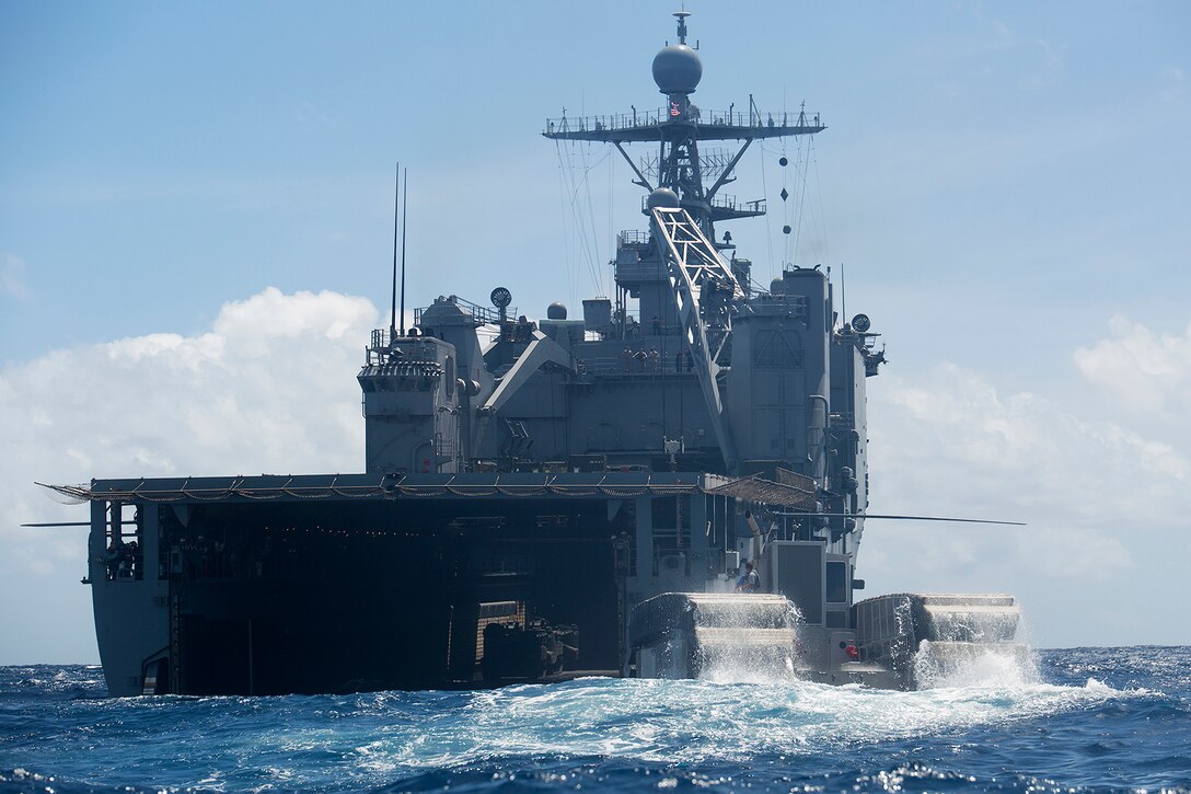 MARINE CORPS TRAINING AREA BELLOWS, Hawaii – The Ultra Heavy-Lift Amphibious Connector prepares to enter the well deck of the USS Rushmore to load up heavy equipment during its first mission off the coast of Marine Corps Training Area Bellows, July 11, during a Marine Corps Advanced Warfighting Experiment. The AWE is the culmination of a decade of progressive experimentation conducted by the Marine Corps Warfighting Lab (MCWL) where they are testing potential future technologies, solutions and concepts to future Marine Air Ground Task Force challenges. The AWE is taking part during the Rim of the Pacific (RIMPAC) Exercise 2014, the world’s largest international maritime exercise. The UHAC prototype is a ship-to-shore connector and is half the size of the intended machine. Currently, the UHAC travels at four knots using a track system with floatation-like pads that propels itself through different terrain. For its first mission, the UHAC paddled two miles off the coast and loaded up an internally transportable vehicle (ITV) aboard the USS Rushmore before disembarking and headed back to MCTAB to offload the vehicle. (U.S. Marine Corps photo by Cpl. Matthew J. Bragg)