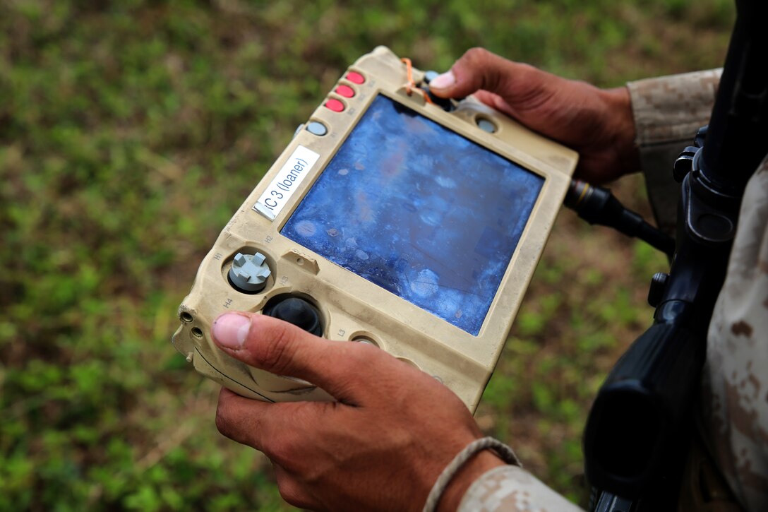Lance Cpl. Brandon Dieckmann, infantryman with India Company, 3rd Battalion, 3rd Marine Regiment, and native of Las Vegas, manuevers the Legged Squad Support System via remote control through a grassy area at Kahuku Training Area, July 12, 2014, during the Rim of the Pacific 2014 exercise. The LS3 is experimental technology being tested by the Marine Corps Warfighting Lab during the Advanced Warfighting Experiment portion of RIMPAC. It is programmed to follow an operator through terrain, carrying heavy loads like water and food to Marines training. There are multiple technologies being tested during RIMPAC, the largest maritime exercise in the Pacific region. This year's RIMPAC features 22 countries and around 25,000 people. (U.S. Marine Corps photo by Sgt. Sarah Dietz/Released)