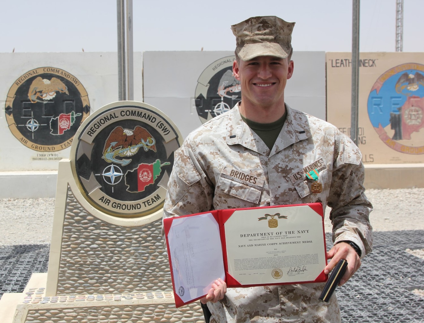 First Lt. Joshua Bridges, a native of Morganton, N.C., and assessments and plans officer, Regional Command (Southwest), poses for a photo after being  awarded a Navy and Marine Corps Achievement Medal during a ceremony aboard Camp Leatherneck, Afghanistan, July 13, 2014. Bridges deployed to Helmand province during Jan. 2014 and was vital to RC(SW) planning efforts during the 2014 Afghan presidential elections and the upcoming transition of full security responsibility to the Afghan National Security Forces in the region by the end of 2014.