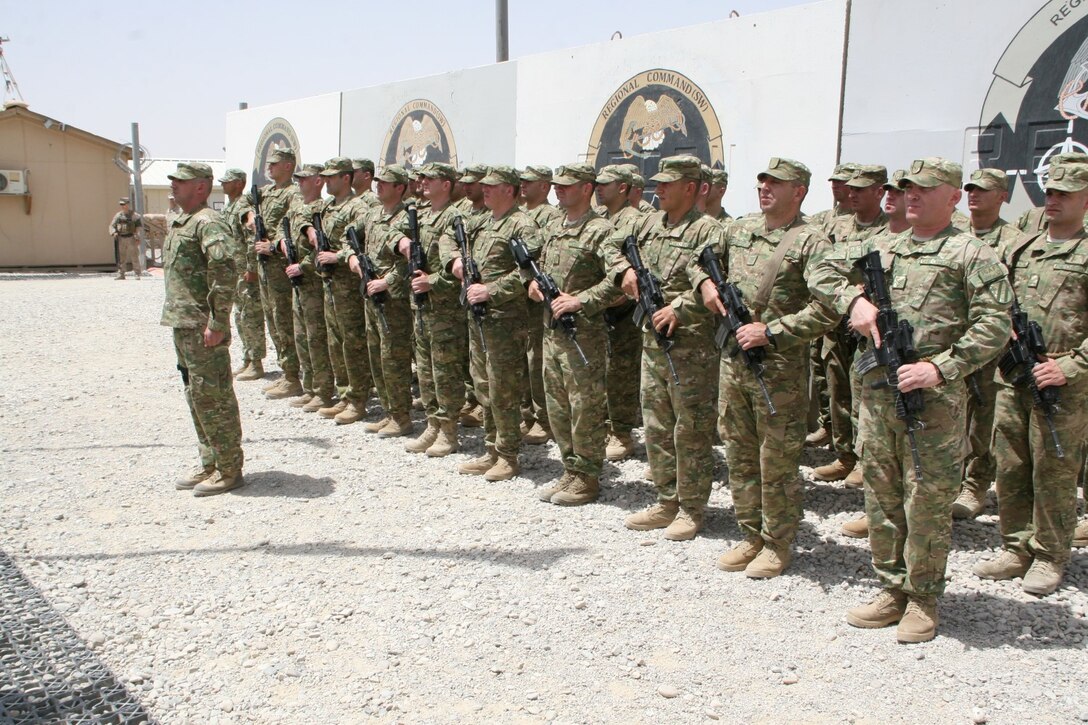 Soldiers with the Republic of Georgia stand in formation during their flag-lowering ceremony aboard Camp Leatherneck, Helmand province, Afghanistan, July 15, 2014. The ceremony marked the end of mission for the Georgian army serving with Regional Command (Southwest).