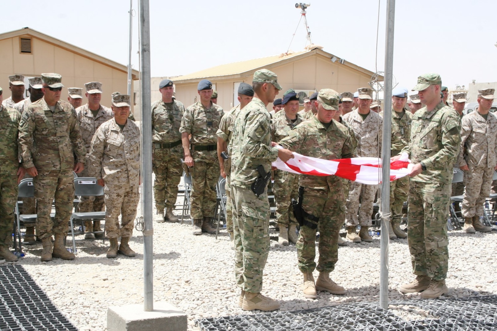 Soldiers with the Republic of Georgia fold their flag during a ceremony aboard Camp Leatherneck, Helmand province, Afghanistan, July 15, 2014. The ceremony marked the end of mission for the Georgian army serving with Regional Command (Southwest).