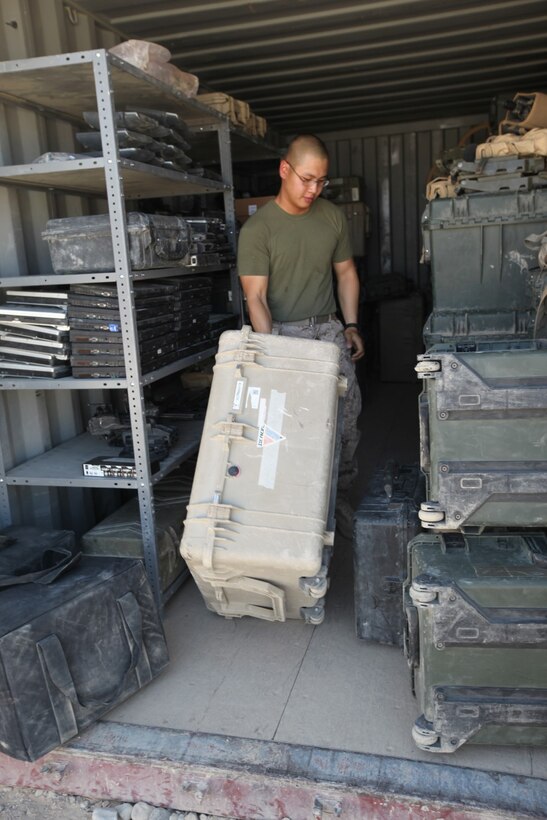 Corporal Tyler Vu, supply administration chief, 1st Battalion, 2nd Marine Regiment, moves some of the battalion's gear during an inventory check aboard Camp Leatherneck, Afghanistan, July 9, 2014. Vu, a native of Brattleboro, Vt., and only four other Marines are the responsible holders and maintainers of 1st Bn., 2nd Marines' $117 million supply of gear and equipment to be retrograded upon the unit,Äôs redeployment. (U.S. Marine Corps Photo By: Sgt. Frances Johnson)