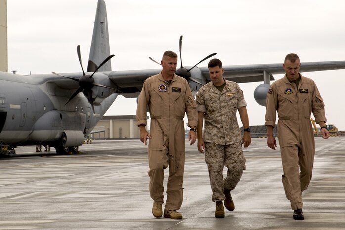 Lt. Col. Matthew W. Stover, commanding officer of Marine Aerial Refueler Transport Squadron 152, left, walks with Col. Robert V. Boucher, commanding officer of Marine Corps Air Station Iwakuni, Japan, middle, and Col. Hunter H. Hobson, commanding officer of Marine Aircraft Group 12 upon arriving at MCAS Iwakuni, July 15, 2014.Upon the KC-130J Super Hercules’ touchdown, administrative control of the squadron effectively changed from MCAS Futenma’s, based out of Okinawa, Japan, Marine Aircraft Group-36 to MAG-12 on Iwakuni. VMGR-152 will remain under operational control of III Marine Expeditionary Force in Okinawa, but MAG-12 will be in charge of providing the squadron with all the gear and supplies necessary in carrying out their missions.