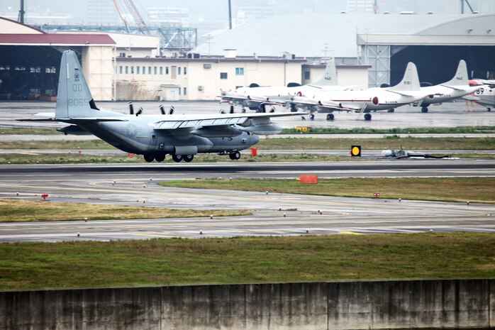 The first KC-130J Super Hercules from Marine Aerial Refueler Transport Squadron 152 (VMGR-152) prepares to land at Marine Corps Air Station Iwakuni, Japan upon the transfer of the squadron from Marine Aircraft Group 36 (MAG-36) to MAG-12.  Upon the KC-130J's touchdown, administrative control of the squadron effectively changed from MCAS Futenma in Okinawa, Japan, to MAG-12 at MCAS Iwakuni.