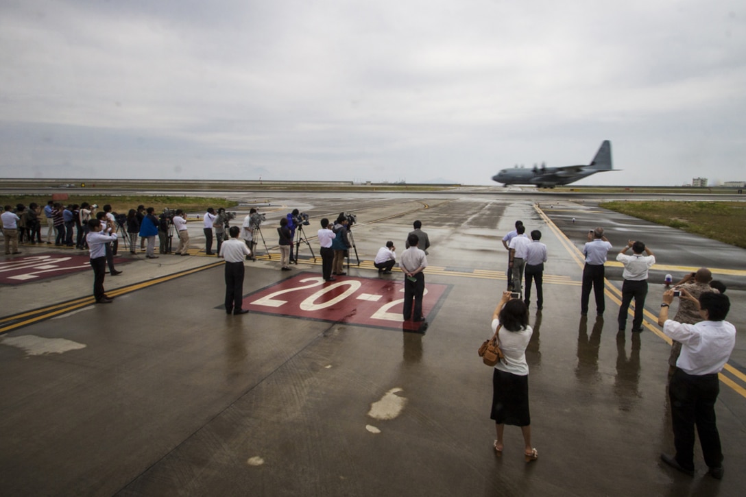 Japanese media takes photographs and video of a KC-130J Super Hercules during its arrival at Marine Corps Air Station Iwakuni, Japan, July 15, 2014. Upon the KC-130J Super Hercules’ touchdown, administrative control of the squadron effectively changed from MCAS Futenma’s, based out of Okinawa, Japan, Marine Aircraft Group-36 to MAG-12 on Iwakuni. VMGR-152 will remain under operational control of III Marine Expeditionary Force in Okinawa, but MAG-12 will be in charge of providing the squadron with all the gear and supplies necessary in carrying out their missions.