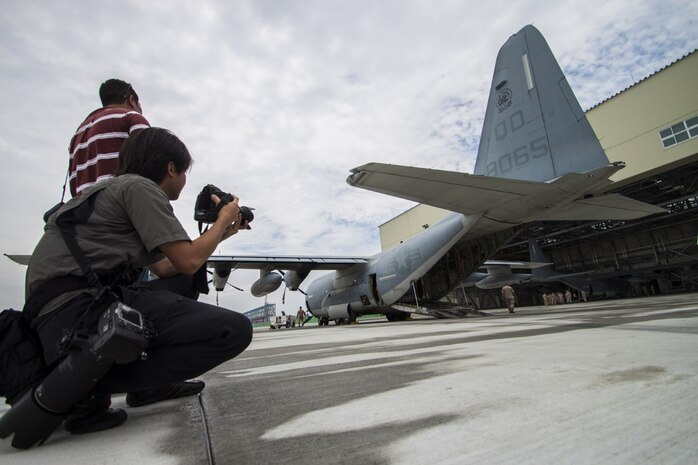 Japanese media takes photographs of a KC-130J Super Hercules after its arrival at Marine Corps Air Station Iwakuni, Japan, July 15, 2014. Upon the KC-130J Super Hercules’ touchdown, administrative control of the squadron effectively changed from MCAS Futenma’s, based out of Okinawa, Japan, Marine Aircraft Group-36 to MAG-12 on Iwakuni. VMGR-152 will remain under operational control of III Marine Expeditionary Force in Okinawa, but MAG-12 will be in charge of providing the squadron with all the gear and supplies necessary in carrying out their missions.