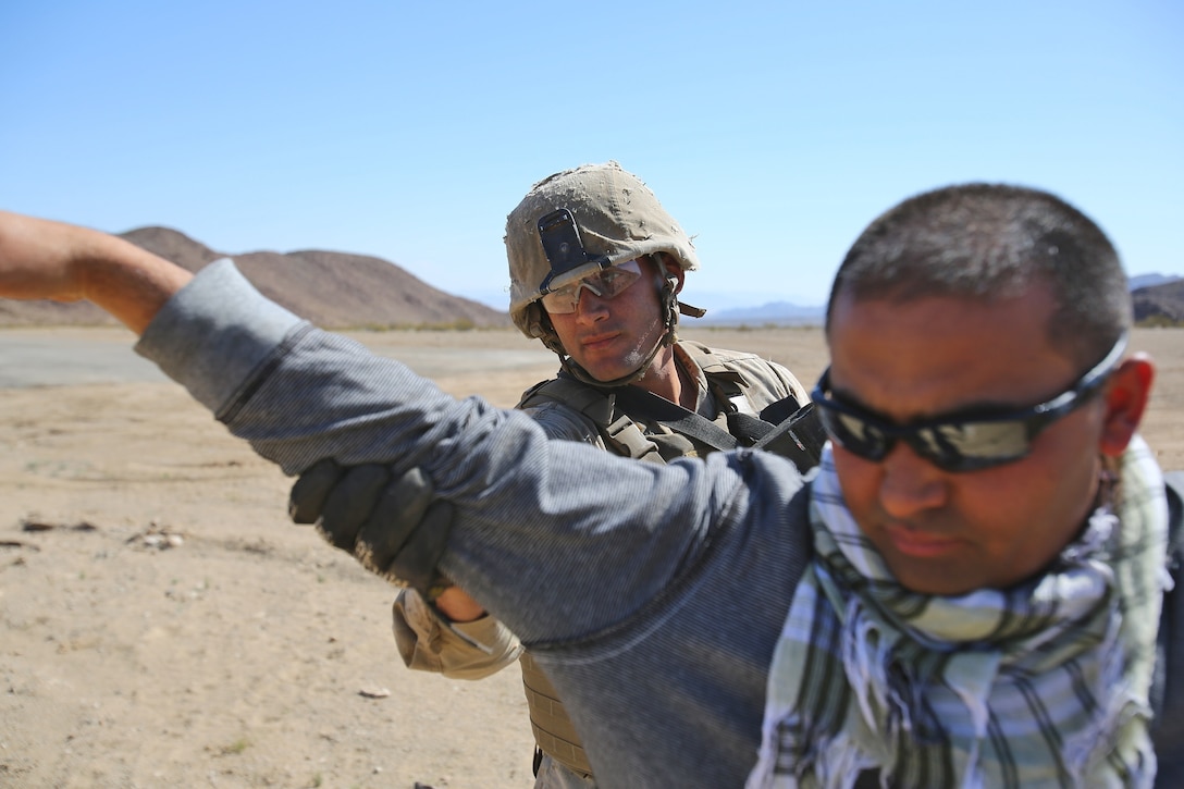 Lance Cpl. Michael J. Clark, motor transportation operator, Transportation Support Company, Combat Logistics Battalion 1, Combat Logistics Regiment 1, 1st Marine Logistics Group, searches Sadat Sultani, a role-player, during the Marine Readiness Exercise aboard Marine Corps Air Ground Combat Center Twenty-nine Palms, Calif., March 25, 2014. The MRX is part of the month-long Integrated Training Exercise 3-14 that prepares the battalion for its role, as the logistics combat element, in the final combat deployment in support of Operation Enduring Freedom.