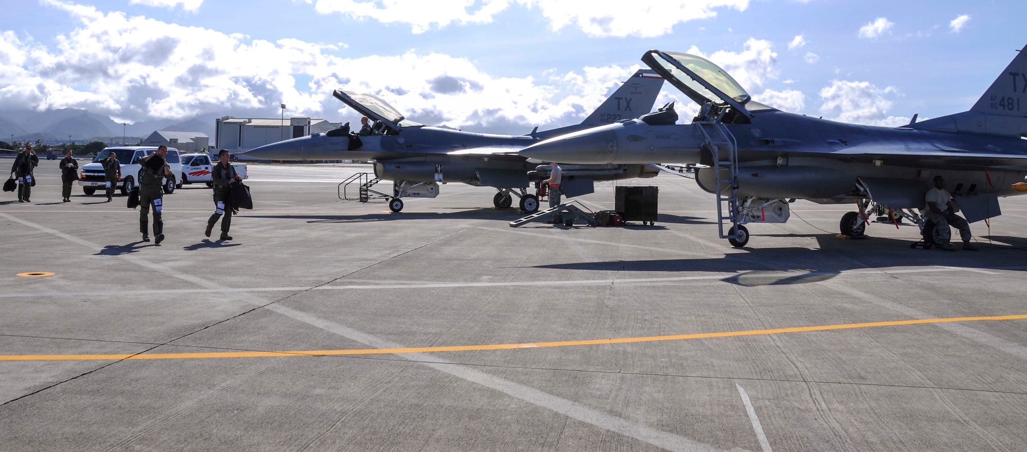 Pilots from the 457th Fighter Squadron at Naval Air Station Fort Worth Joint Reserve Base Carswell Field, Texas, walk toward the F-16C Fighting Falcons parked on the flightline at Joint Base Pearl Harbor-Hickam, Hawaii, in preparation for a training mission in support of Rim of the Pacific 2014 July 15, 2014. Twenty-two nations, more than 40 ships and submarines, more than 200 aircraft and 25,000 personnel are participating in RIMPAC exercise from June 26 to Aug. 1, in and around the Hawaiian Islands.  The world's largest international maritime exercise, RIMPAC provides a unique training opportunity that helps participants foster and sustain the cooperative relationships that are critical to ensuring the safety of sea lanes and security on the world's oceans. (U.S. Air Force photo by Tech. Sgt. Mario Dorado) 