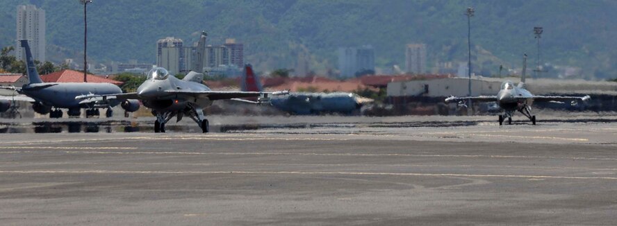 F-16C Fighting Falcons from the 457th Fighter Squadron at Naval Air Station Fort Worth Joint Reserve Base Carswell Field, Texas, taxi on the flightline at Joint Base Pearl Harbor-Hickam, Hawaii, in preparation for a training mission in support of Rim of the Pacific 2014 July 15, 2014. Twenty-two nations, more than 40 ships and submarines, more than 200 aircraft and 25,000 personnel are participating in RIMPAC exercise from June 26 to Aug. 1, in and around the Hawaiian Islands. The world's largest international maritime exercise, RIMPAC provides a unique training opportunity that helps participants foster and sustain the cooperative relationships that are critical to ensuring the safety of sea lanes and security on the world's oceans. (U.S. Air Force photo by Tech. Sgt. Mario Dorado) 