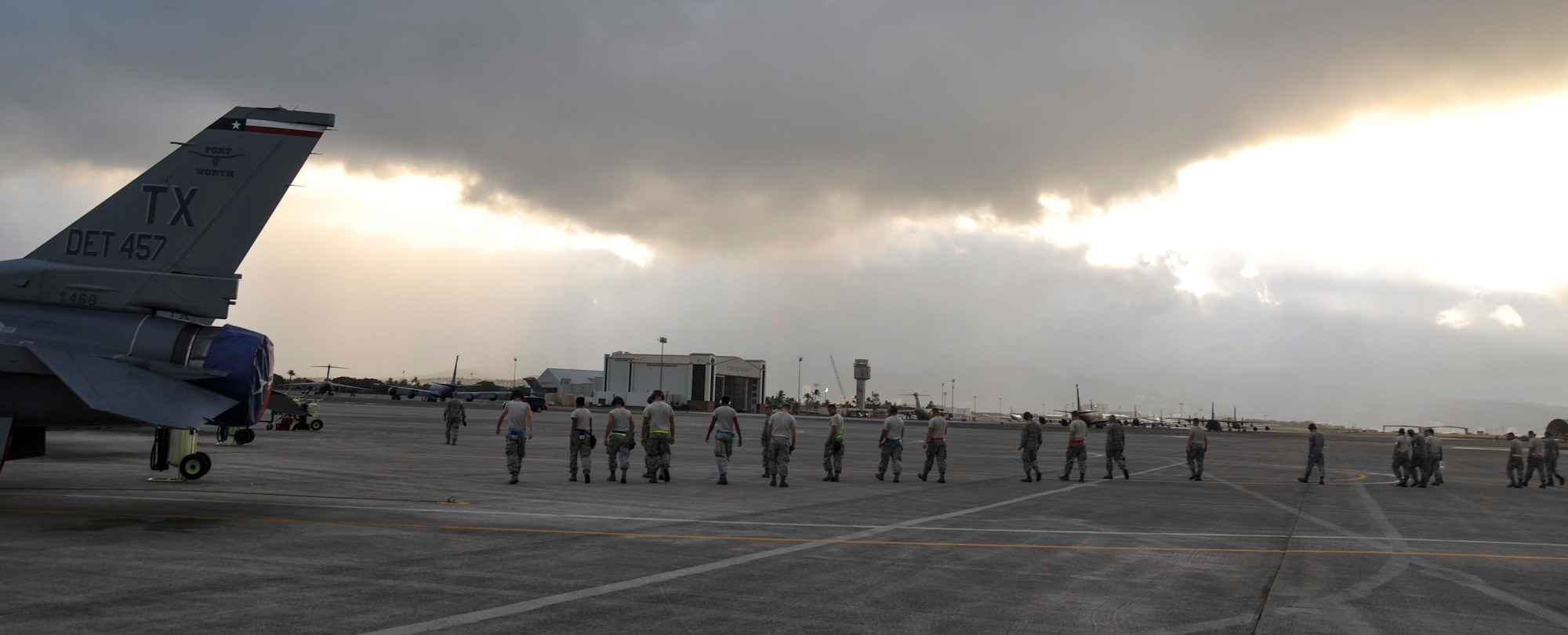 Airmen from the 457th Fighter Squadron at Naval Air Station Fort Worth Joint Reserve Base Carswell Field, Texas, conduct a foreign object debris walk on the flightline at Joint Base Pearl Harbor-Hickam, Hawaii, July 15, 2014. The Airmen are here in support of  Rim of the Pacific 2014. Twenty-two nations, more than 40 ships and submarines, more than 200 aircraft and 25,000 personnel are participating in RIMPAC exercise from June 26 to Aug. 1, in and around the Hawaiian Islands.  The world's largest international maritime exercise, RIMPAC provides a unique training opportunity that helps participants foster and sustain the cooperative relationships that are critical to ensuring the safety of sea lanes and security on the world's oceans. (U.S. Air Force photo by Tech. Sgt. Mario Dorado)