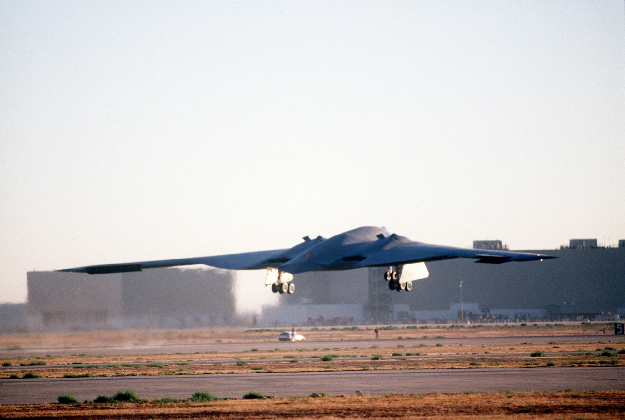 A B-2 Spirit bomber takes off July 17, 1989, from the Northrop Grumman production facility in Palmdale, California on its inaugural flight to Edwards Air Force Base, California. The B-2 would remain in the testing phase until 1993, when the first operational aircraft was delivered to Whiteman AFB, Missouri. (Defense Imagery Management Operations Center photo/Released) 
