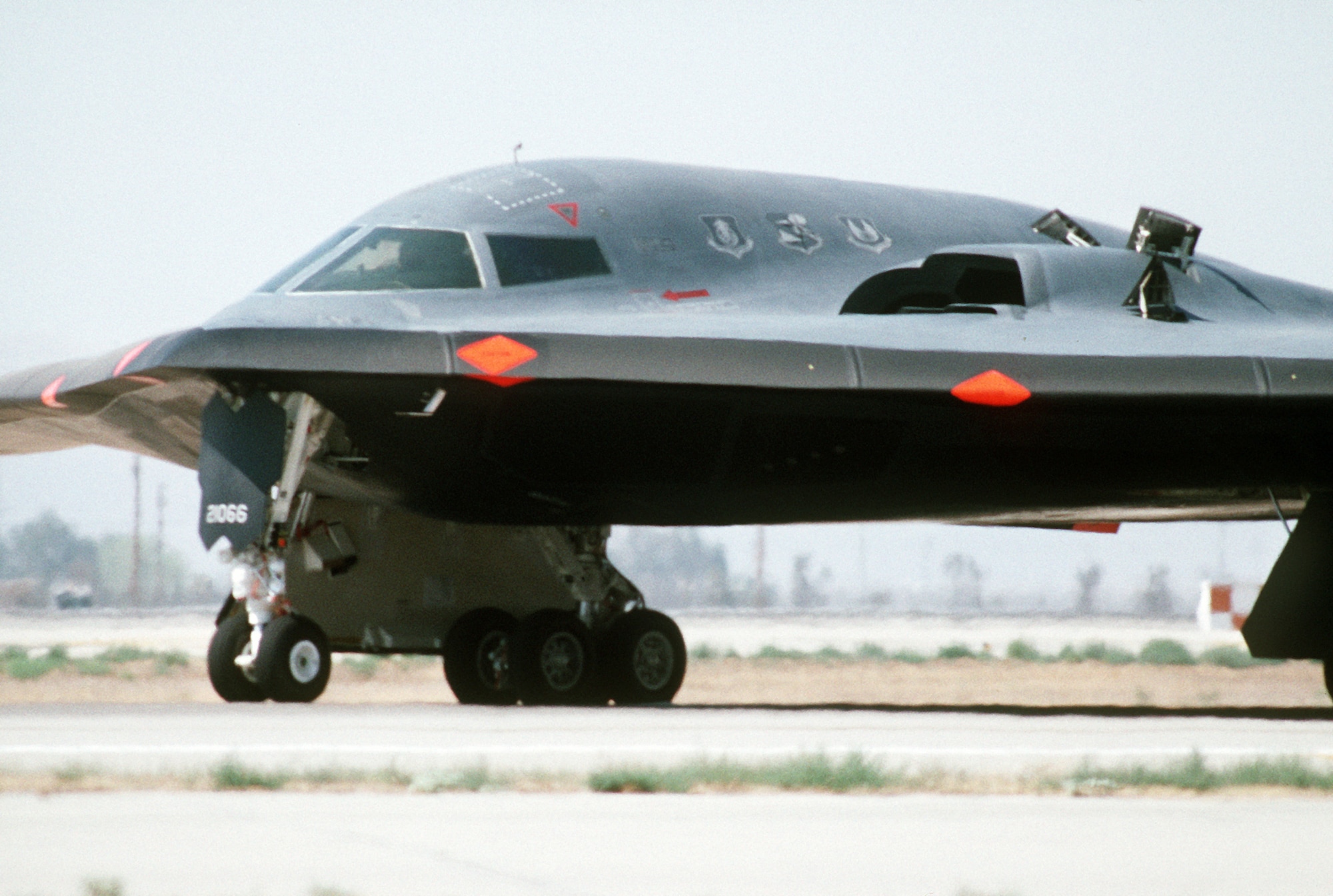 A front-left view of a B-2 advanced technology bomber on the runway at the Air Force Flight Test Center for its first flight. (U.S. Air Force photo/Alan Wycheck)