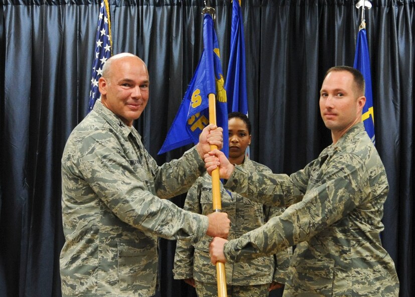 Maj. David Watts assumes command of the 2nd Security Forces Squadron from Col. Patrick Matthews, 2nd Mission Support Group commander, during a change of command ceremony at Barksdale Air Force Base, La., July 11, 2014. Before taking command of the 2nd SFS, Watts was previously a student at the National Intelligence University, Joint Base Anacostia-Bolling, District of Columbia. (U.S. Air Force photo/Senior Airman Kristin High)
