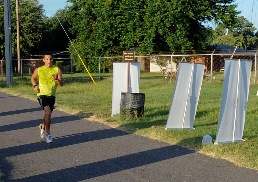 Senior Master Sgt. Randall Kingfisher, Air Force Global Strike Command, races to the finish line of the Freedom 5K fun run on Barksdale Air Force Base, La., July 11, 2014. Kingfisher finished the run with an time of 18:50. (U.S. Air Force photo/Senior Airman Kristin High)
