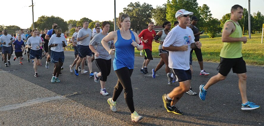 Team Barksdale members take off during the Freedom 5K fun run on Barksdale Air Force Base, La., July 11, 2014. The Senior Airman Bryan Bell Fitness Center hosts a 5K fun-run each month to promote health and wellness and fitness. Prizes are given to the 1st and 2nd place males and females and a raffle is also held for all participants. (U.S. Air Force photo/Senior Airman Kristin High)
