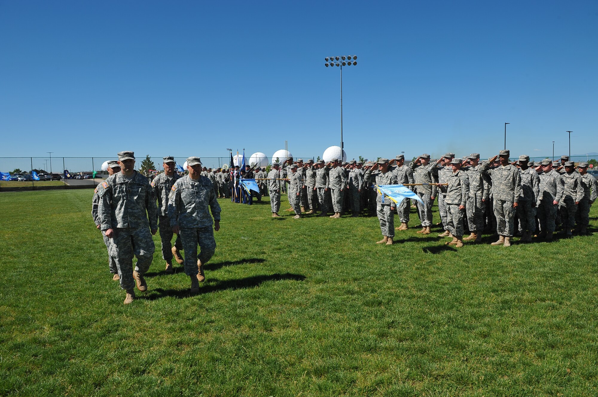 The command team performs a pass in review during the 743rd Military Intelliegence Battalion change of command ceremony June 19, 2014, at the softball fields on Buckley Air Force Base, Colo. During the ceremony, Lt. Col. Andrew Pelka, 743rd MI Battalion commander, assumed command from Lt. Col. Gary Hausman after two years of service to the unit. (U.S. Air Force photo by Senior Airman Phillip Houk/Released)