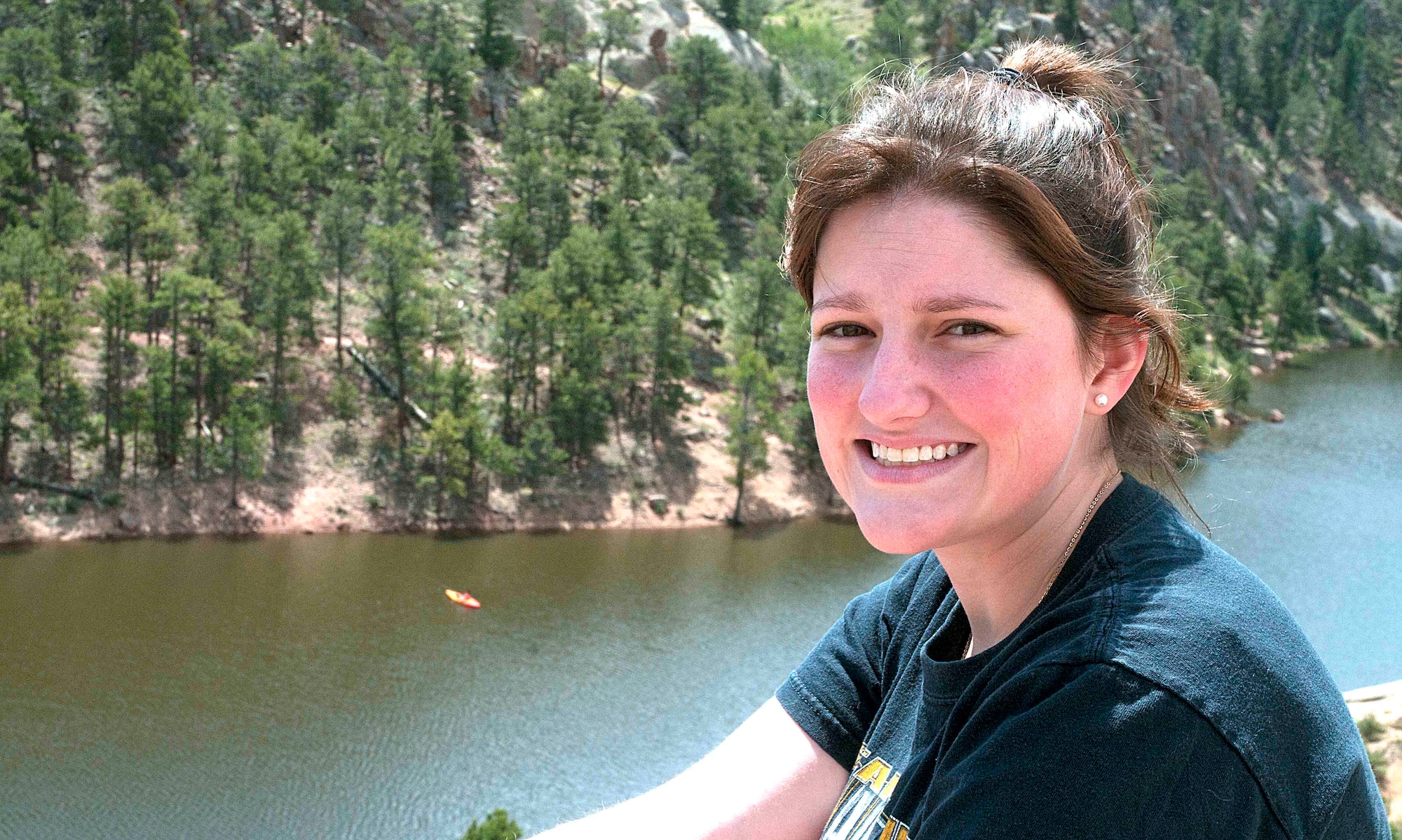 140713-F-CQ929-158 Airman 1st Class Siobhan Lynch, 90th Medical Group, smiles for the camera July 11 while sitting on a boulder after a mile and a half hike in Curt Gowdy State Park. The park has more than 30 miles of trails for both hiking and mountain biking. (U.S. Air Force photo by Airman Malcolm Mayfield)
