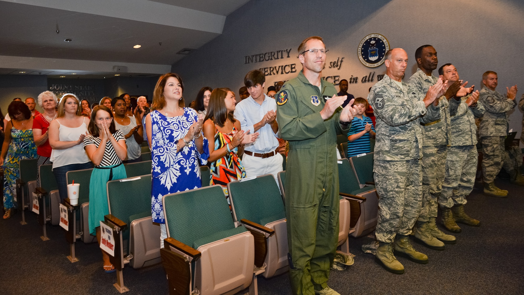 Family members, friends and coworkers cheer on members of the 202nd Engineering Installation Squadron (EIS), during a Hometown Heroes Salute ceremony at Robins Air Force Base, Ga., July 13, 2014. 
Members of the 202nd EIS received numerous awards to include Bronze Star Medals, Air Force and Army Commendation and Achievement Medals and Hometown Heroes Awards for meritorious service while deployed in support of the global war on terrorism.   (U.S. Air National Guard photo by Master Sgt. Roger Parsons/Released)  
