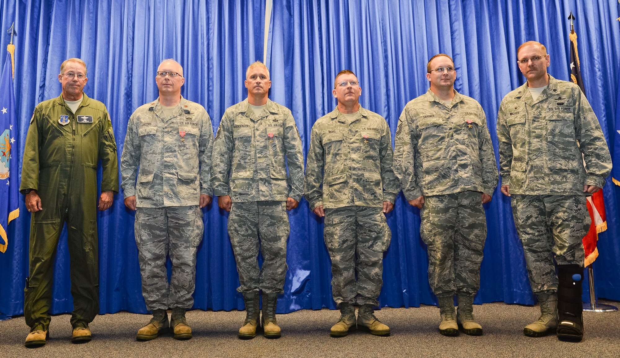 U.S. Air Force Maj. Gen. Thomas Moore, left, commander of the Georgia Air National Guard, and Lt. Col. Fred Walker, commander of the 202nd Engineering Installation Squadron (EIS), far right, pose with four members of the 202nd EIS after presenting them with Bronze Star medals during a Hometown Heroes Salute ceremony at Robins Air Force Base, Ga., July 13, 2014. Receiving the Bronze Star for meritorious service while deployed to Afghanistan in support of the global war on terrorism were; Maj. Will Jacobs, 2nd from left, Senior Master Sgts. Mark Buchanan and George Kight and Master Sgt. Jason Gardner.   (U.S. Air National Guard photo by Master Sgt. Roger Parsons/Released)