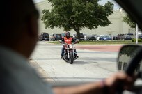 Dale Owens, 12th Flying Training Wing, rides off base on his motorcycle June 24, from Joint Base San Antonio-Randolph. Proper safety gear such as a Department of Transportation approved helmet, pants made of thick material, a reflective vest and protective footwear ensure the riders safety, thus making them clearly visible to other drivers. (U.S. Air Force photo by Johnny Saldivar) 