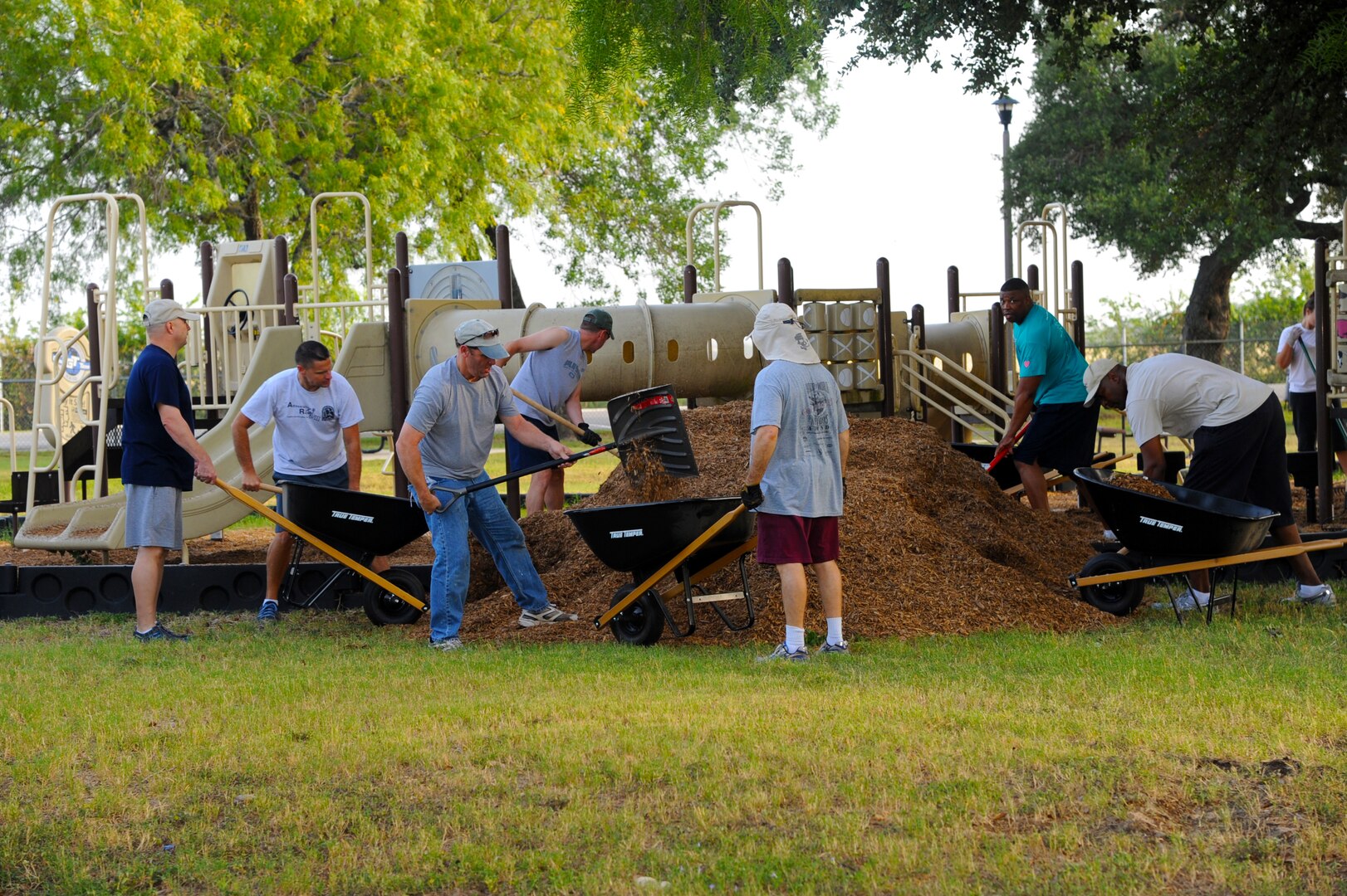 More than 20 enlisted Airmen participated in the Eberle Park Renovation project  July 12 at Joint Base San Antonio-Randolph. The day’s mission included spreading mulch in playgrounds, adding sand to the outside volleyball court, power-washing, painting, and cleaning up. Volunteers were members of either the Randolph Top Three or Randolph Chief’s Group. (U.S. Air Force photo by Senior Airman Kenna Jackson)
