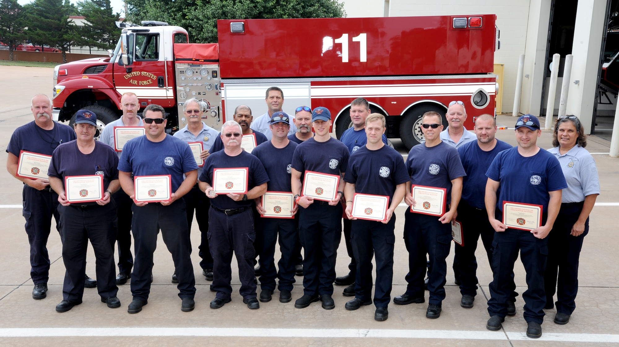 VANCE AIR FORCE BASE, Okla. -- Team Vance firefighters line up to display certificates recognizing them as firefighters for the state of Oklahoma July 15 outside the fire station. Forty-four Team Vance firefighters received certificates from the Oklahoma Council of Firefighter Training recognizing them as advanced or master firefighters. (U.S. Air Force photo/Senior Airman Frank Casciotta)