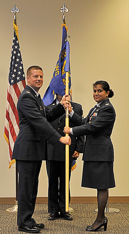 Col. Frank L. Amodeo, 403rd Wing commander (left), passes the guidon to Col. Beena N. Maharaj, 403rd Mission Support Group commander, during an assumption of command ceremony at the Roberts Auditorium, Keesler Air Force Base, Mississippi, July 13, 2014.  Maharaj assumed command of the 403rd MSG during the 403rd Wing July unit training assembly.  (U.S. Air Force photo by Master Sgt. Jessica Kendziorek)