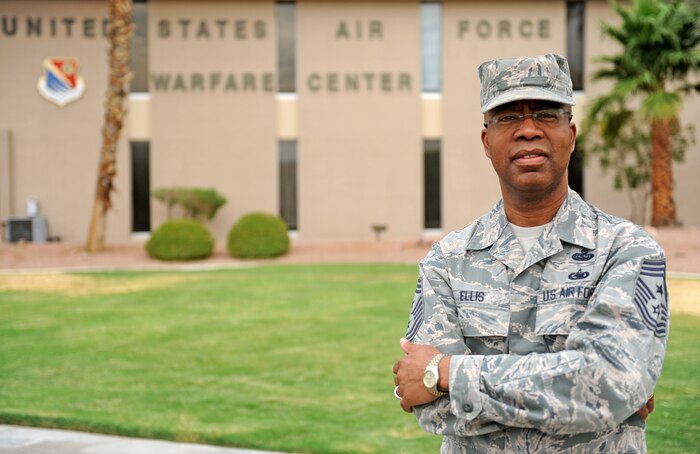 Chief Master Sgt. Robert A. Ellis, U.S. Air Force Warfare Center command chief, poses for a photo outside of the U.S. Air Force Warfare Center headquarters building at Nellis Air Force Base, N.V., July 16, 2014. Ellis, who will be retiring after serving 30 years in the Air Force, has held various duties ranging from squadron to major-command level. His stateside assignments include bases in South Dakota, Nevada, Arizona, Texas, Virginia and Colorado. The Chief also served overseas in the United Kingdom, the Netherlands, Japan and Turkey, and has deployed in support of Operations Desert Shield, Allied Force and Enduring Freedom. (U.S. Air Force photo by Staff Sgt. Siuta B. Ika)
