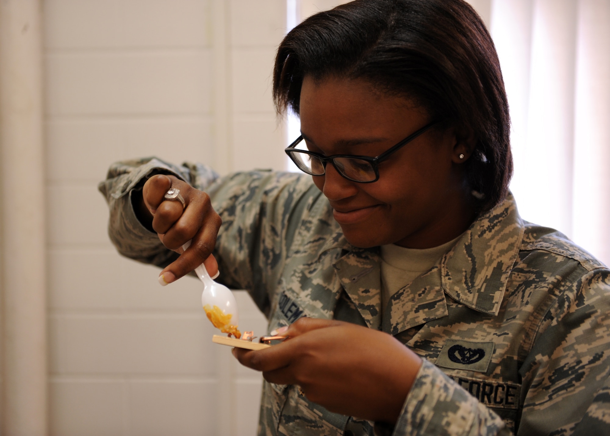 Airman 1st Class Debretta Coleman, a 19th Civil Engineer Squadron pest management apprentice, baits a mouse trap with peanut butter June 24, 2014, at Little Rock Air Force Base, Ark. Mice can cause damage to wiring, supplies and can even spread disease. (U.S. Air Force photo by Airman 1st Class Scott Poe)