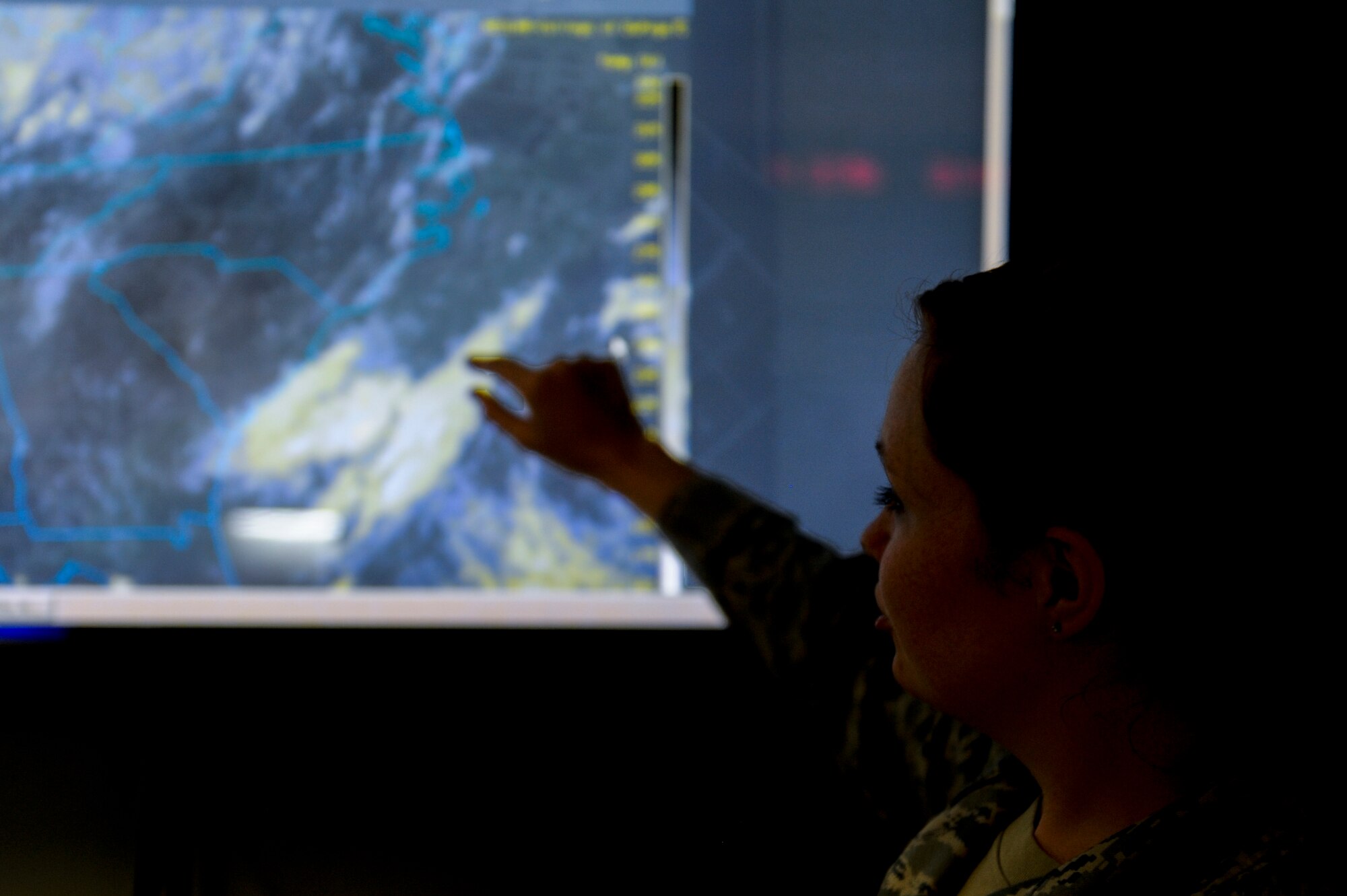 Staff Sgt. Robin Powers, 4th Operations Support Squadron weather journeyman, describes weather patterns over the Atlantic Ocean, July 14, 2014, at Seymour Johnson Air Force Base, North Carolina. The Seymour Johnson weather office briefs pilots and weapon systems officers with up-to-the-minute weather conditions for a 200,000 square mile area before every flying operation. (U.S. Air Force photo/Airman 1st Class Aaron J. Jenne)