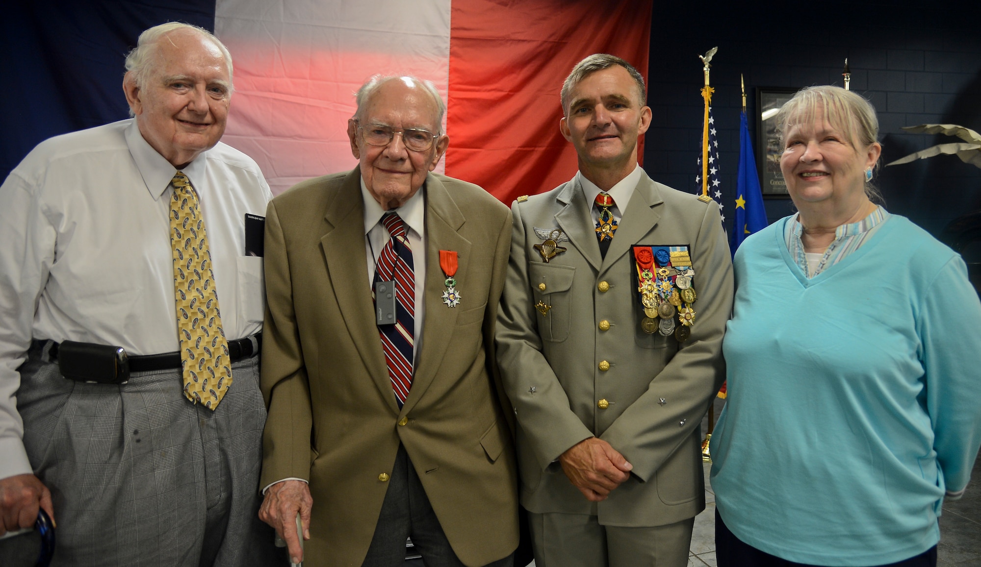 French army Brig. Gen. Bernard Commins, U.S. Central Command French senior national representative, stands with former Army Capt. Robert Staib, French Legion D’Honneur recipient, and family at a French National Day celebration in Tampa, Florida, July 14, 2014. Staib served during World War II in Normandy, Ardennes, Central Europe, Northern Europe and Rhineland and was wounded in action in Belgium on Dec. 28, 1944. (U.S. Air Force photo by Airman 1st Class Ned T. Johnston/Released)