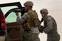 Airmen from the 91st Missile Security Forces Squadron search a vehicle during a training exercise in North Dakota, July 11, 2014. The purpose of this training is to maintain readiness for launch facility recapture. (U.S. Air Force photo/Senior Airman Brittany Y. Bateman)