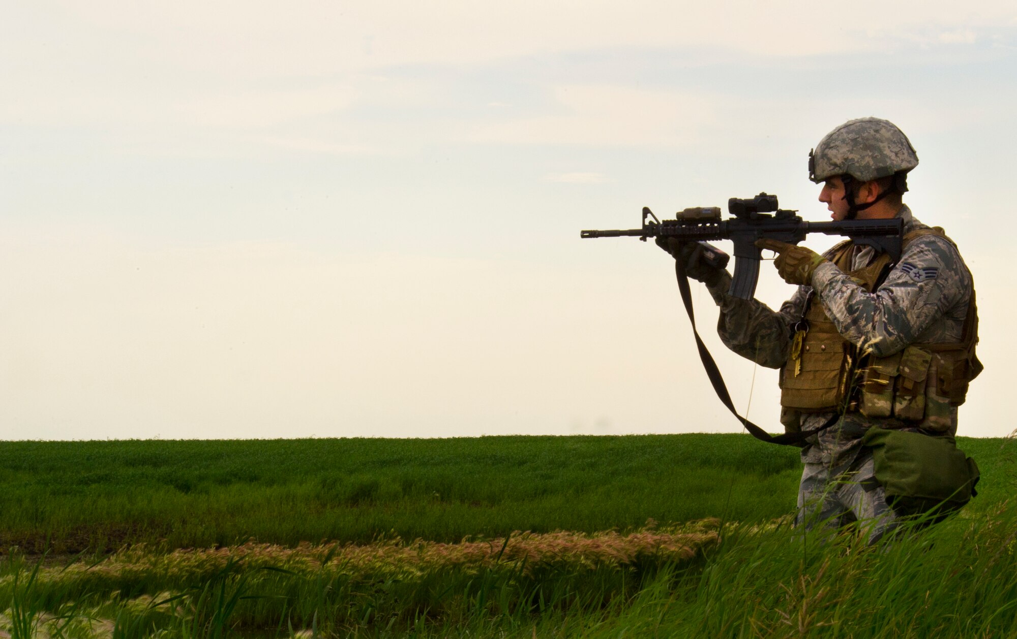 Senior Airman Steven Sanchez, 91st Missile Security Forces Squadron flight security controller, provides cover during a training exercise in North Dakota, July 11, 2014.  The purpose of this training is to maintain readiness for launch facility recapture. (U.S. Air Force photo/Senior Airman Brittany Y. Bateman)