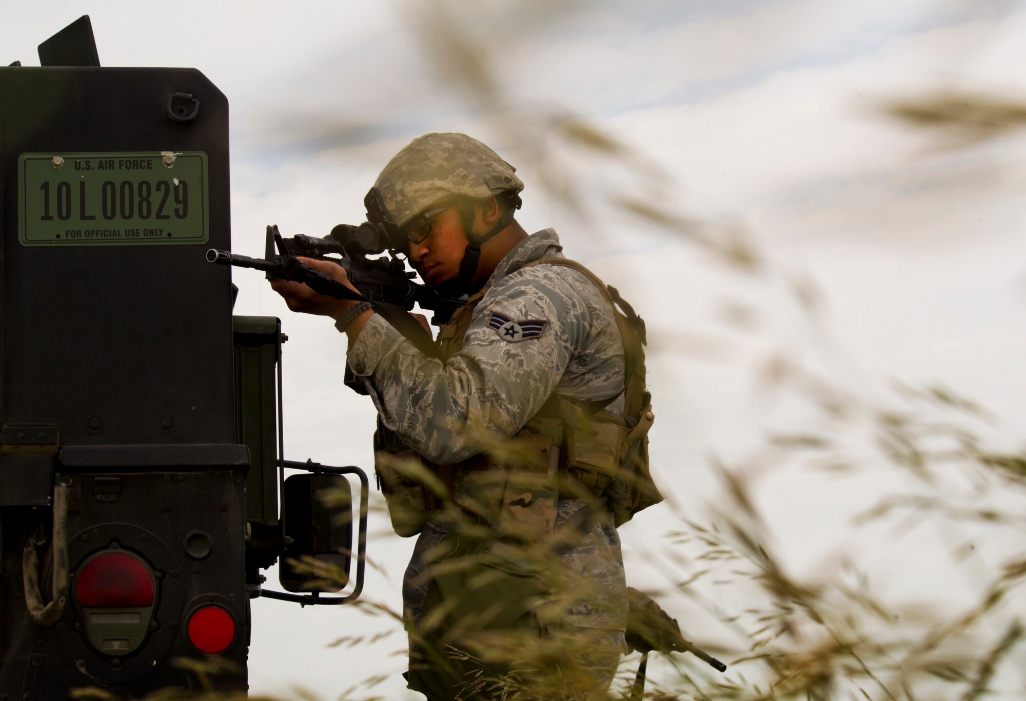 Senior Airman Aaron Bowser, 91st Missile Security Forces Squadron response force leader, provides cover during a training exercise in North Dakota, July 11, 2014.  The exercise is used as a training tool to evaluate the responding forces, their reaction of denying access to the resource from hostile actions and recovery of the resource if access is gained. (U.S. Air Force photo/Senior Airman Brittany Y. Bateman)