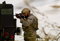 Senior Airman Aaron Bowser, 91st Missile Security Forces Squadron response force leader, provides cover during a training exercise in North Dakota, July 11, 2014.  The exercise is used as a training tool to evaluate the responding forces, their reaction of denying access to the resource from hostile actions and recovery of the resource if access is gained. (U.S. Air Force photo/Senior Airman Brittany Y. Bateman)