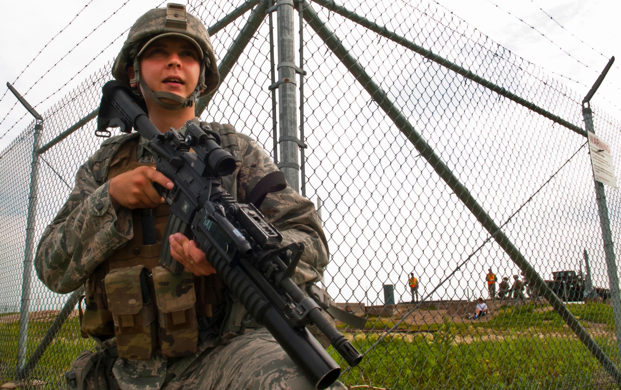Airman 1st Class Hunter Snowman, 91st Missile Security Forces Squadron response force member, guards the outer perimeter of a launch facility during a training exercise in North Dakota, July 11, 2014. The exercise is to evaluate the response of infield forces to an attack at a simulated breached site. (U.S. Air Force photo/Senior Airman Brittany Y. Bateman)