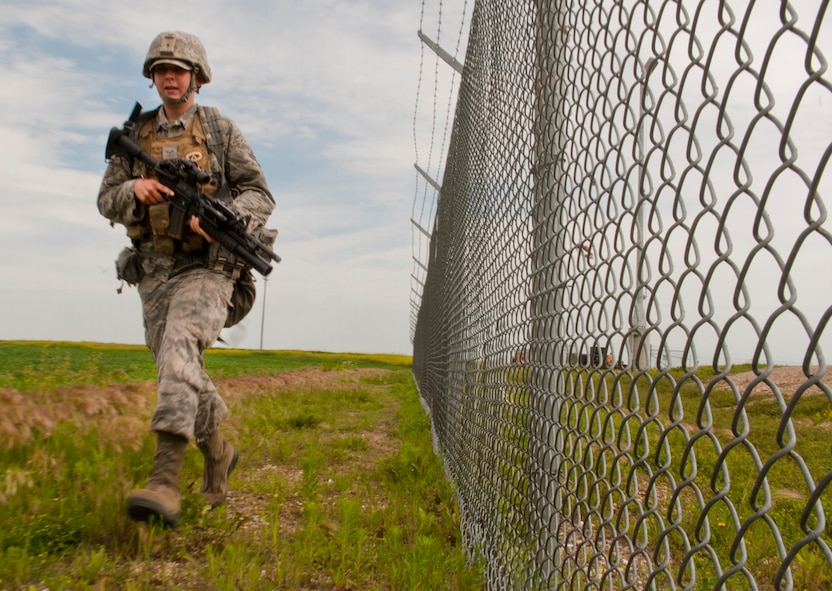 Airman 1st Class Hunter Snowman, 91st Missile Security Forces Squadron response force member, runs to his position during a training exercise in North Dakota, July 11, 2014. The exercise simulated an opposing force taking over a launch facility and the defenders then recovering the asset. (U.S. Air Force photo/Senior Airman Brittany Y. Bateman)