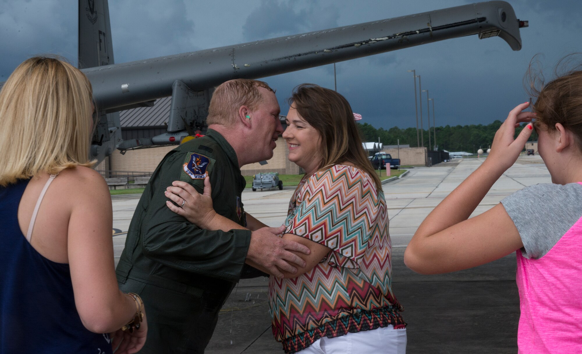 U.S. Air Force Col. Steve Ramer, 23d Wing vice commander, embraces his wife Anne Ramer as their daughters Kristen, left, and Alexis Ramer  look on at Moody Air Force Base, July 15, 2014. This was Ramer’s  last flight at Moody before he moves on to Osan Air Base, Republic of Korea. (U.S. Air Force photo by Airman 1st Class Sandra Marrero/Released)
