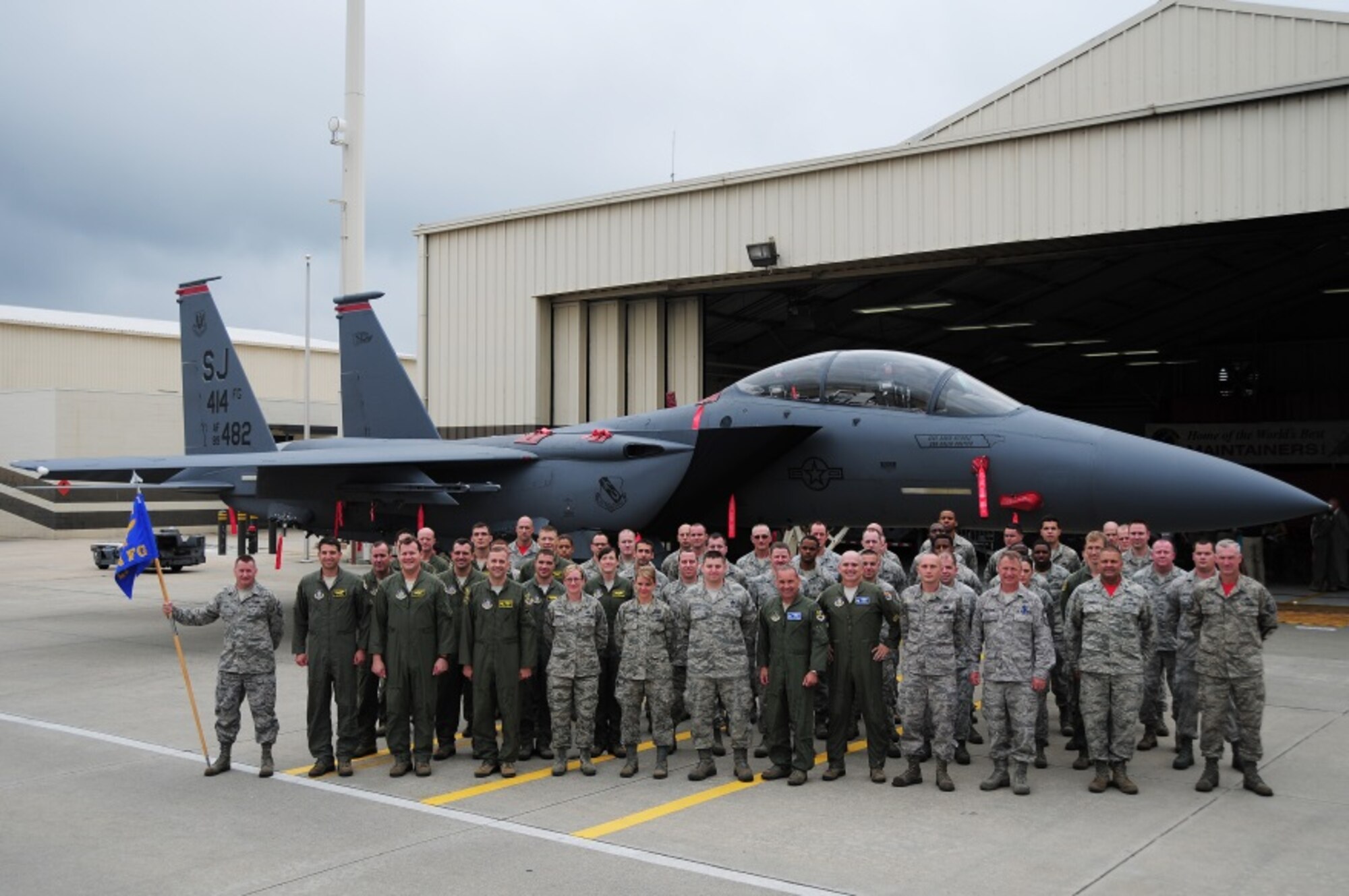 Airmen from the 414th Fighter Group, Col. Christopher Freeman, 414th Fighter Group commander, and Col. Kurt Gallegos, 944th Fighter Wing commander, pose for a group photo after a change of command ceremony held at Seymour Johnson Air Force Base July 11, 2014. Freeman assumed command of the 414th FG after serving as the 414th Maintenance Squadron commander. (U.S. Air Force photo by Staff Sgt. Lausanne Kinder)