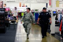 Airman 1st Class Shawna Grocott and Officer Marcelo Aguillon Jr., 902nd Security Forces Squadron security officers, walk down aisles in the Exchange June 11 at Joint Base San Antonio-Randolph. According to military legal code, military police members may apprehend suspects if probable cause is established. (U.S. Air Force photo illustration by Desiree Palacios)
