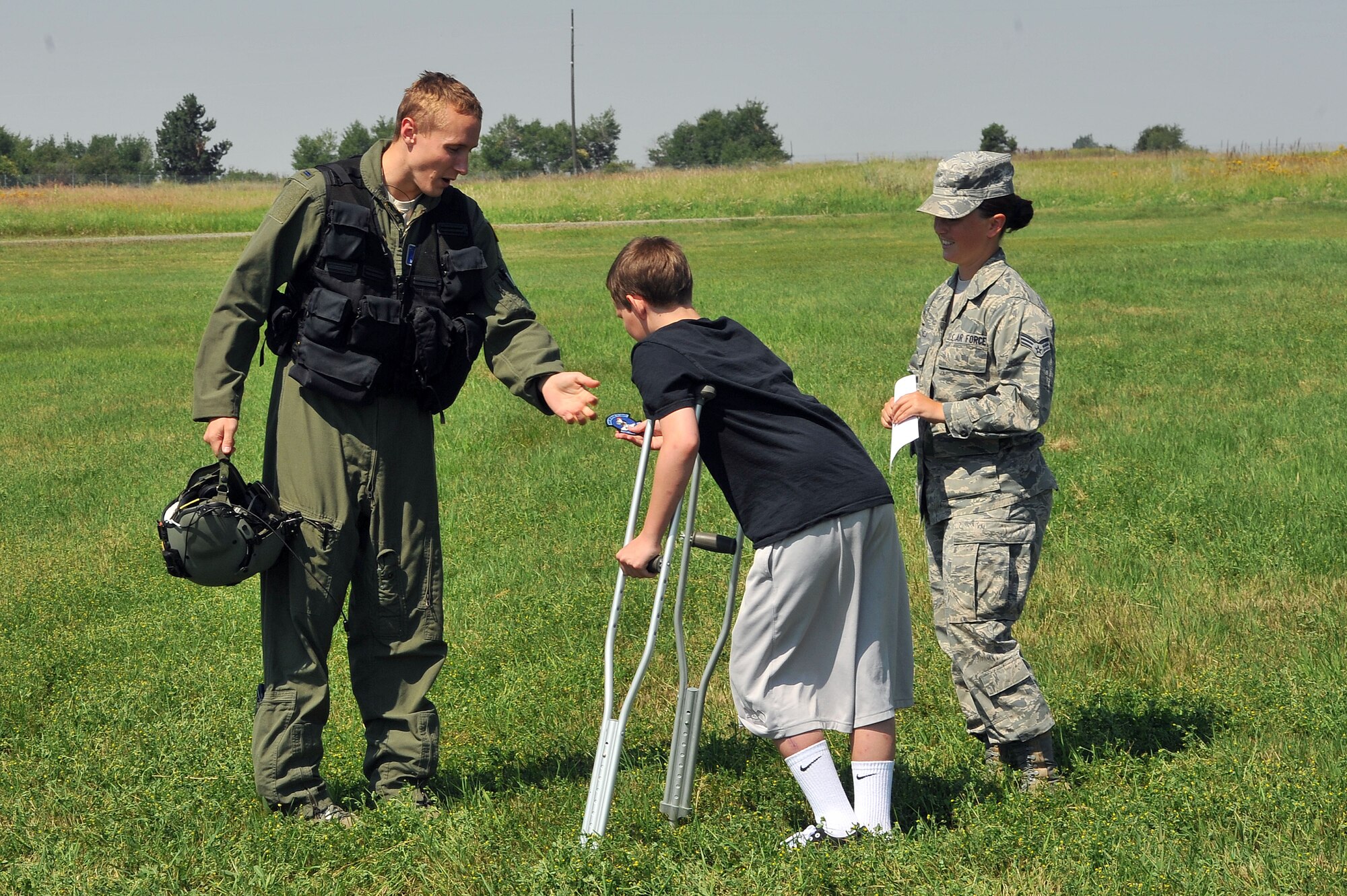 Zayne Rutter receives a 36th Rescue Flight unit patch after a flight during 'Airman for a Day' July 11, 2014, at Fairchild Air Force Base, Washington. Zayne was hit in a nearly-fatal vehicle accident in May and has been in and out of hospitals since. This program allows children like Zayne to experience the Air Force for a day and escape the current challenges they may be facing. (U.S. Air Force photo by Staff Sgt. Veronica Montes/Released)
