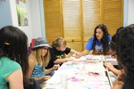 Kayla McKenney (right), Youth Program Staff volunteer, gives assistance to Juliette Gerst (left) and Alex Gerst in an art class July 9 during the Joint Base San Antonio 2014 Military & Family Readiness Arts and Dance Camp at JBSA-Randolph. (U.S. Air Force photo by Melissa Peterson)
