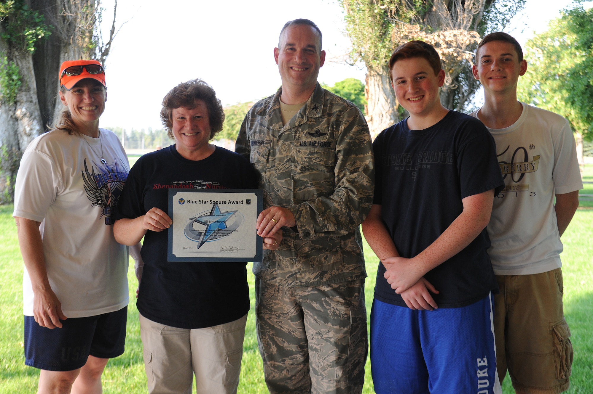 Col. Brian Newberry and Chief Master Sgt. Wendy Hansen along with Mark and Matthew Newberry present the colonel’s final Blue Star Spouse Award to his wife, Jill Newberry, at Fairchild Air Force Base, Washington, July 15, 2014. Mrs. Newberry went above and beyond supporting Airmen and their families in her time as first lady for the wing providing tireless encouragement and inspiration on and off base. Colonel Newberry is the 92nd Air Refueling Wing commander and Hansen is the 92nd ARW command chief. In total, 22 Blue Star spouse awards were presented to those nominated for making a difference for families and the Fairchild mission. (U.S. Air Force photo by Airman 1st Class Janelle Patiño/Released)