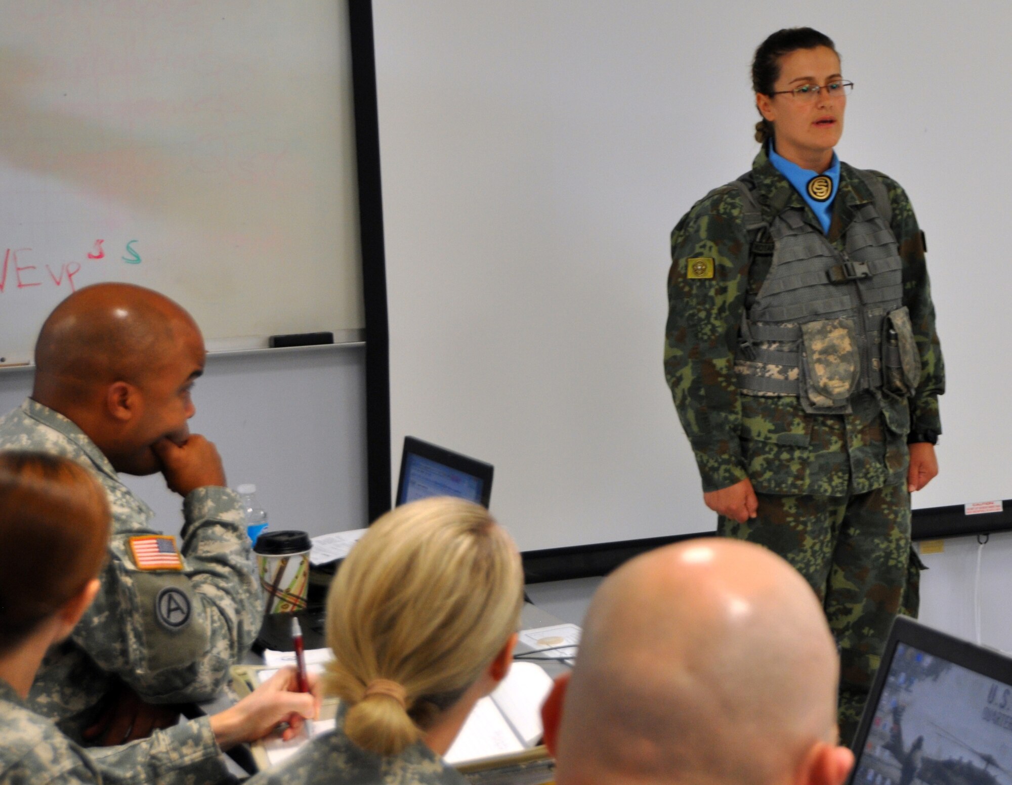 Albanian Sgt. Marjana Kotarja speaks to U.S. Army officers about the Officer Candidate School she is currently attending at Joint Base Dix-McGuire-Lakehurst, N.J. The New Jersey National Guard is conducting the OCS for 24 Albanian soldiers as part of the State Partnership Program. (U.S. Army photo by Staff Sgt. Bert Crespo/Released)