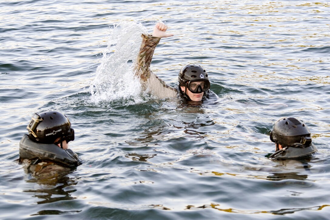 Staff Sergeant Dallas Stoll (center), 22nd Special Tactics Squadron combat controller instructs two Airmen from the 22nd STS Red Team on the proper technique for hoist extraction operations July 14, 2014, during helocast alternate insertion and extraction training with Soldiers from the 160th Special Operations Aviation Regiment at American Lake on Joint Base Lewis-McChord, Wash. Stoll, a helocast master, was chosen to be the team leader for the exercise to ensure the members of Red Team could get the proper upgrade training. (U.S. Air Force photo/Staff Sgt.Russ Jackson)